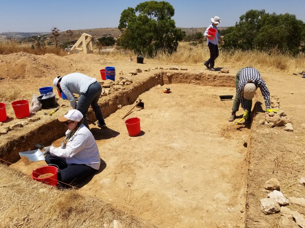 Workers making perfectly straight sides to a trench