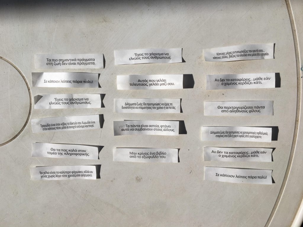 Several fortune cookie fortunes on a table