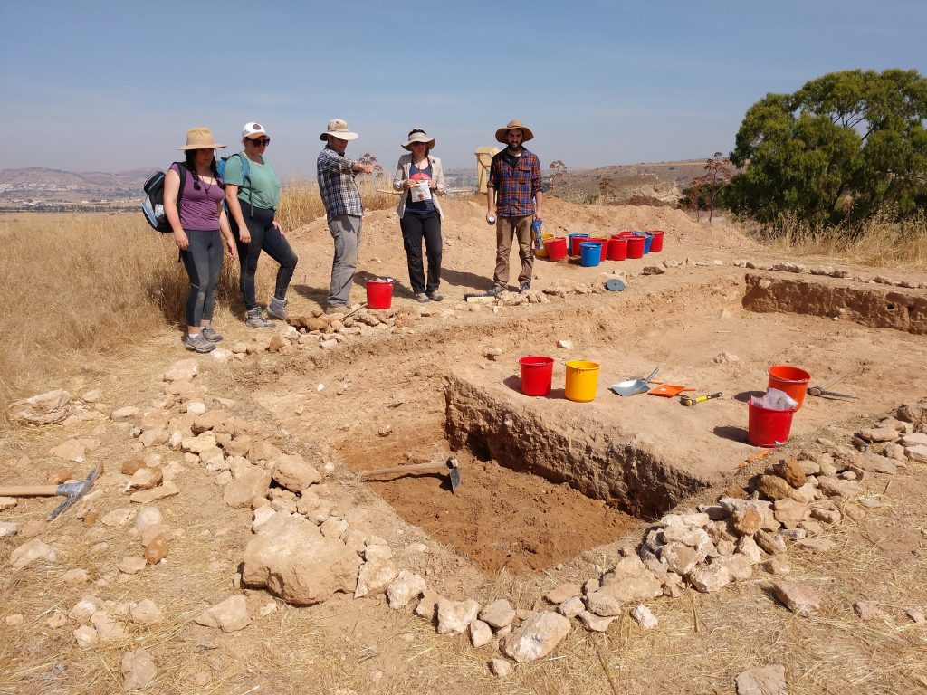 An archaeological trench with two levels of soil dug, revealing two different stratigraphic units