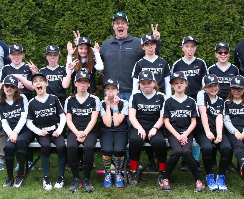 Lawrence Sherman, class of 1986, pictured center, poses with his Southwest Portland Little League team. Lawrence has been a volunteer coach for Little League since 2005. 