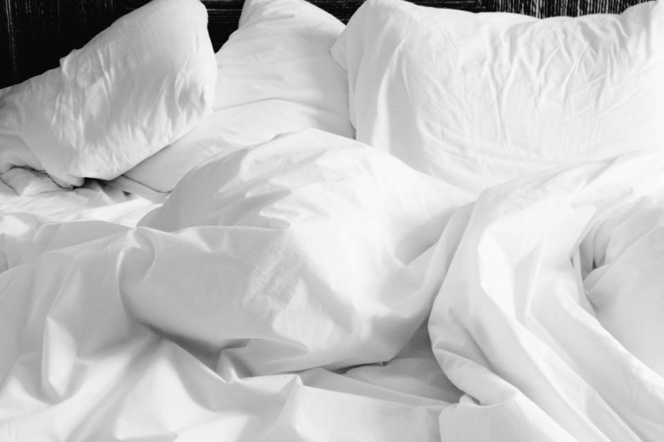 White pillows on a unmade bed