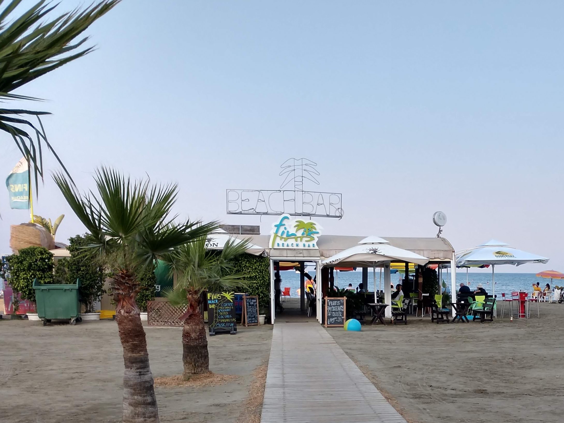 A bar on the beach at the end of a boardwalk