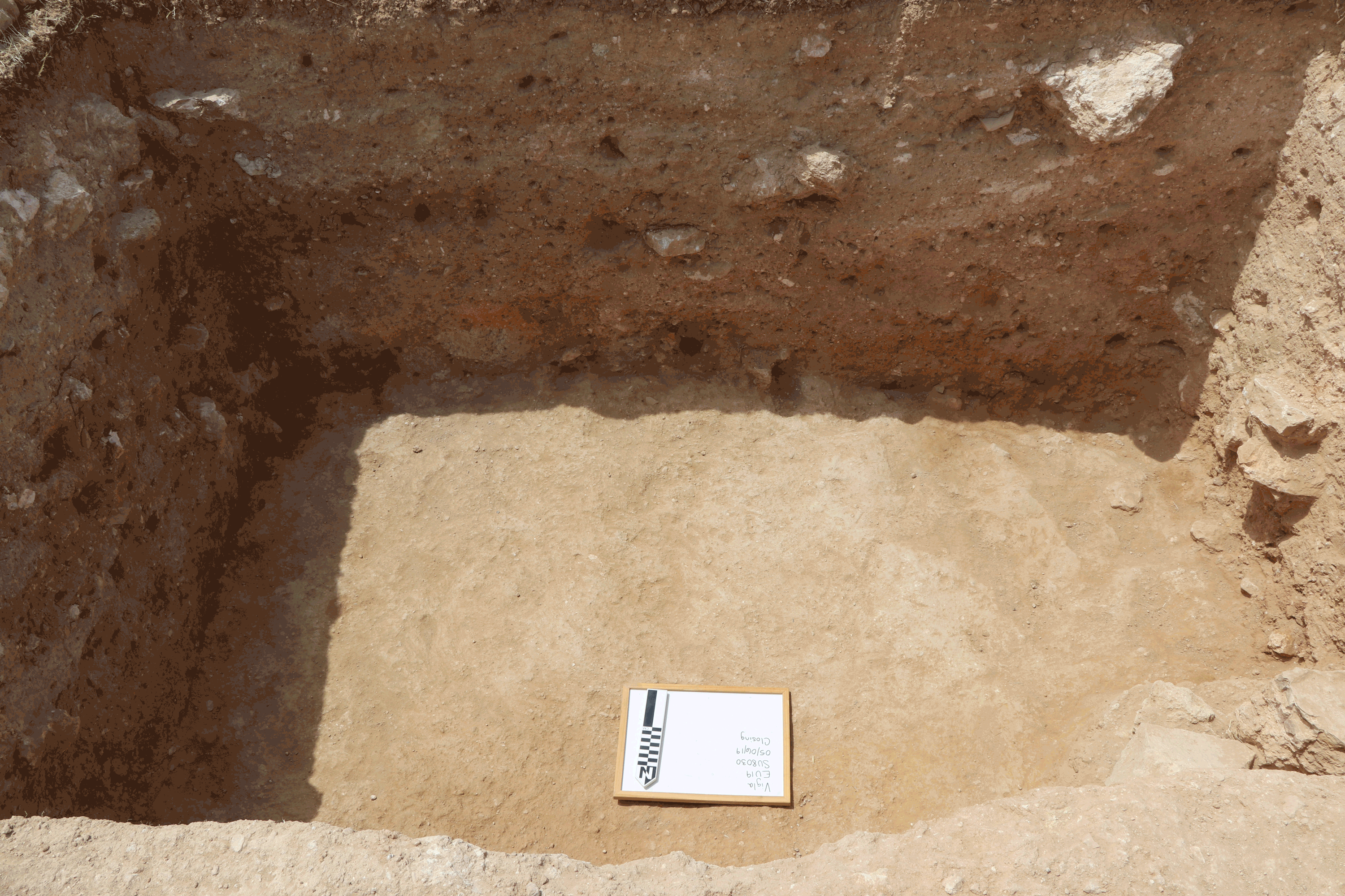 GIF showing a pit in the ground with many labeled mudbricks.